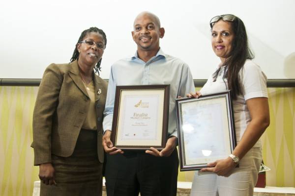 Vivian Ann Gittens presenting Certificates to the Finalist in the Medium Business Category, Oceans Two (middle) and Bougainvillea Beach Resort (right)