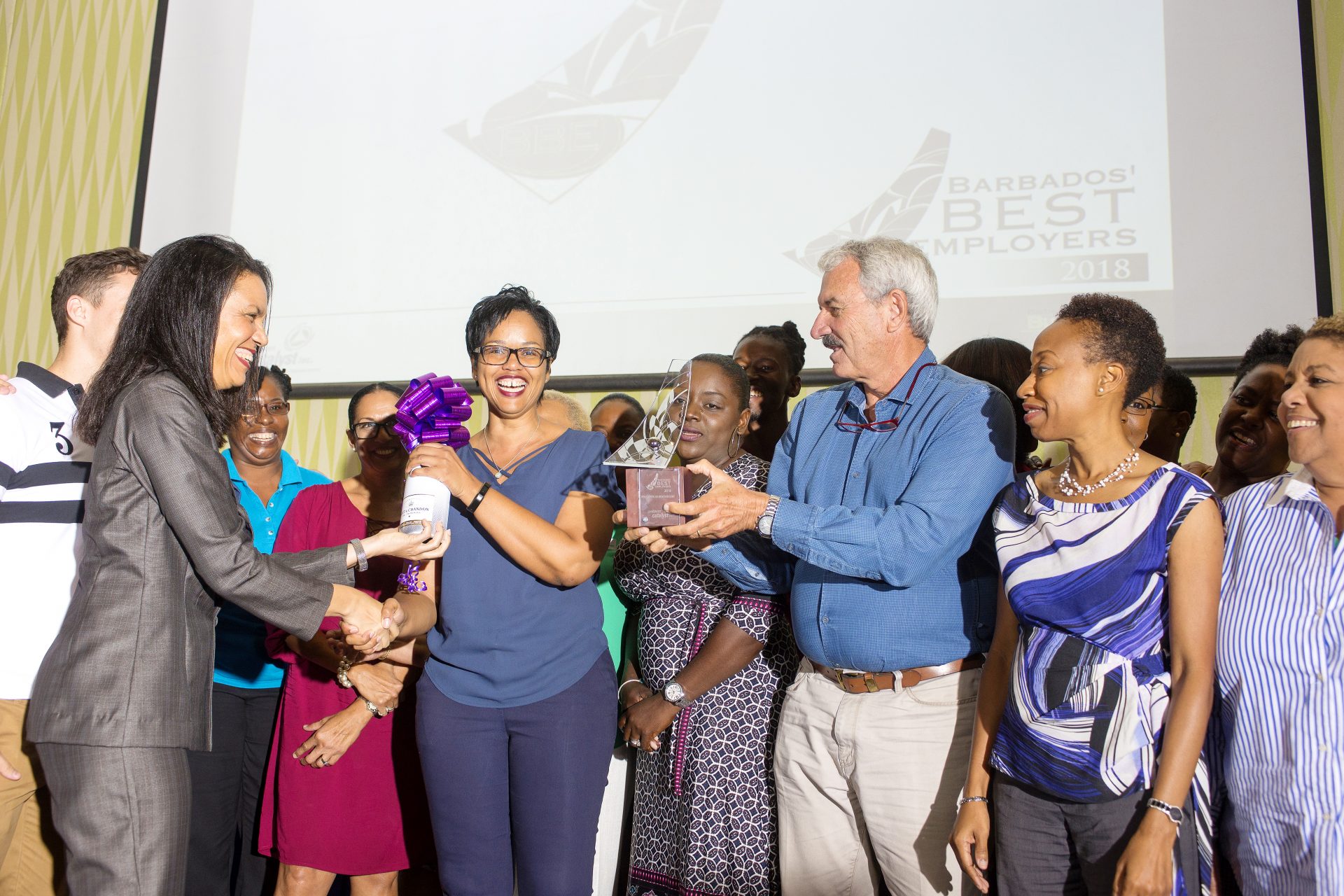 Laura Husbands at Caribbean Catalyst Inc. presenting the award to Bougainvillea Winner in the Large category
