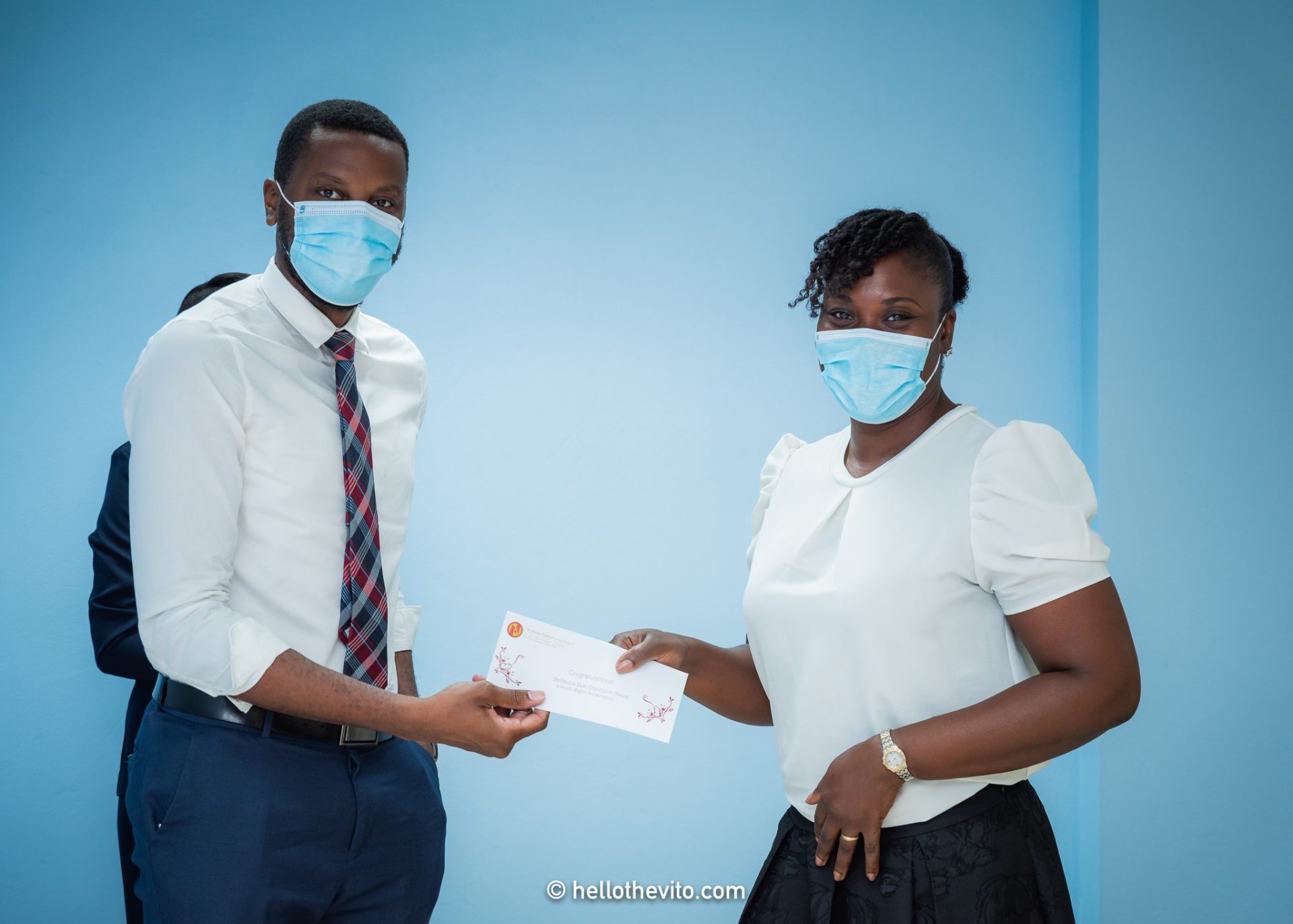 Romaine Lovell, Marketing Executive at Nation Group presenting six months subscription to the Business Authority to Simone Forde.